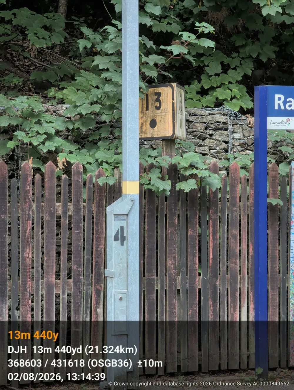 A photo of a milepost stamped along the bottom with the ELR, mileage, grid reference and time.